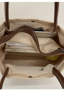 Detail view of large canvas tote bag interior with zipper pockets and spacious storage