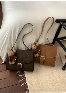 Retro faux suede flap shoulder bags with gold horseshoe buckles and plush bear charms