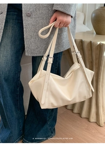 Minimalist creamy white shoulder bag with adjustable silver buckles and soft pleats