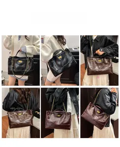 Detail of quilted leather tote bag with metal chain strap and twist lock closure