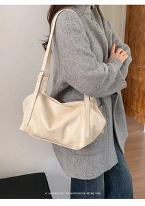Detail of cream white PU leather tote bag with adjustable silver buckle shoulder strap