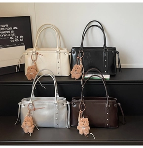 Detail view of retro tote bags in four colors with cute teddy bear charms and studs