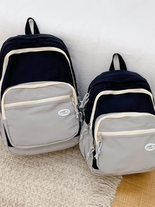 Black and grey macaron backpack with contrast piping in two sizes for students