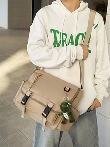 Waterproof khaki canvas messenger bag with large capacity and cute dinosaur pendant