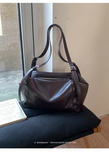 Macro view of retro dark brown leather tote bag with functional front metal zipper detail