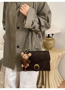 Retro dark brown square shoulder bag featuring a gold horseshoe buckle and cute bear charm