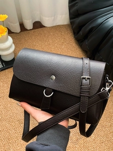 Classic dark brown leather crossbody bag with silver buckle and adjustable shoulder strap