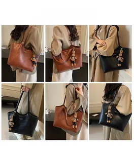 Detail view of large capacity tote bags in brown and black with cute bunny charms