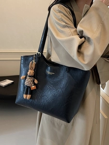 Large vintage black leather tote bag with a cute rabbit pendant for daily commuting