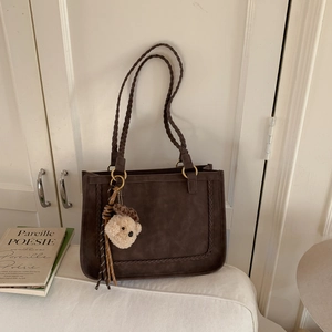 Vintage brown frosted tote bag with woven handles and a cute plush bear charm decoration