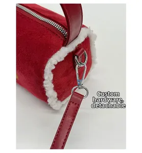 Detail of red matte cylinder bag with fleece trim and detachable metal hardware