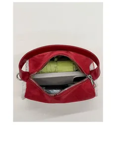 Top view of red suede handbag interior showing space for phone and umbrella