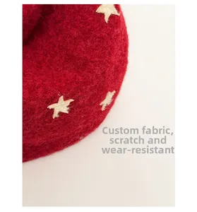 Close-up of red plush fabric with star embroidery and durable scratch-resistant texture