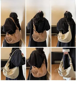 Detail view of adjustable wide shoulder straps and drawstring pleats on hobo bags