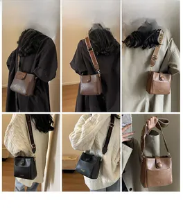 Detail of vintage square crossbody bag with wide straps in black, brown and camel colors