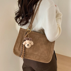 Brown faux suede tote bag with woven handles and cute plush dog charm detail