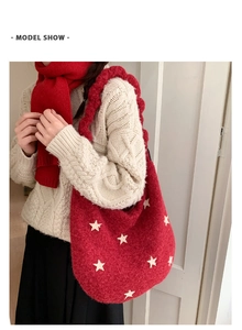 Detail of red knit tote bag with white star pattern and thick woven shoulder strap