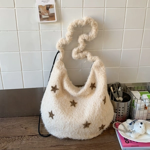 Detail of white plush shoulder bag featuring embroidered stars and thick textured strap