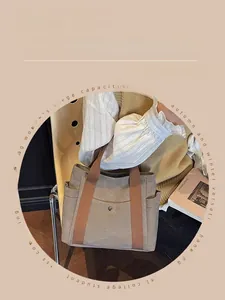 Detail of canvas tote bag showing side pocket and brown leather trim for commuting