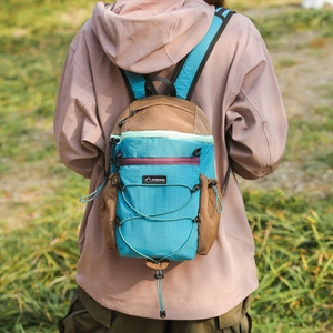 Detail of water-resistant skin bag showing cross bungee cord system and grid texture