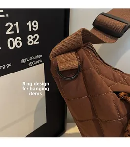 Détail de l'anneau de suspension sur le sac bandoulière matelassé marron café