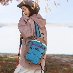 Lightweight foldable blue outdoor shoulder bag with cross elastic cord detail