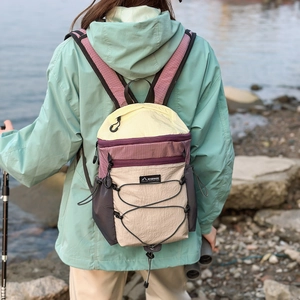 Outdoor foldable backpack detail showing water-resistant nylon texture and bungee cord