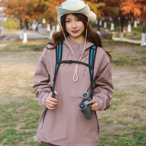 Detail of pink hooded windbreaker with waterproof zipper pocket and sun hat for hiking