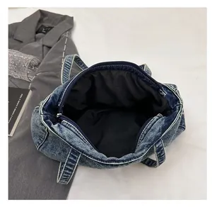 Detailed interior of vintage washed denim crossbody bag showing zipper and spacious lining
