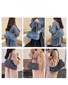 Detail view of denim shoulder bags in light blue and dark grey worn by a model