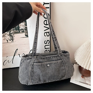 Detailed close-up of smoky gray denim shoulder bag with vintage metal buckle design