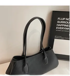 Detail of black litchi pattern leather tote bag with sturdy and comfortable shoulder straps