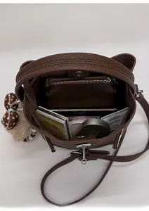 Interior view of brown bucket bag showing spacious storage for makeup and daily essentials