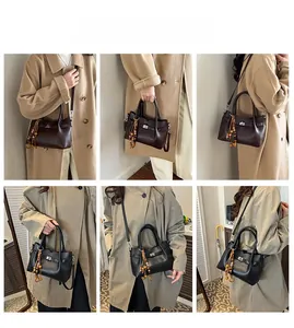 Detail view of vintage soft leather bucket bags with wooden beads and silver clasp
