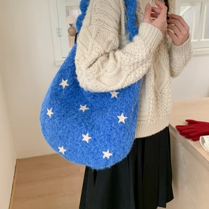 Detail of blue plush star shoulder bag showing soft fuzzy texture and spacious design