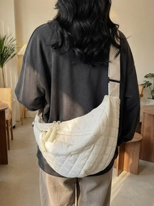 Sac bandoulière demi-lune blanc en nylon matelassé avec sangle réglable sur mannequin