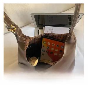 Macro view of hobo bag interior showing storage space for tablet and smartphones