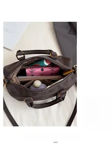 Interior view of leather Boston bag showing spacious compartments and storage capacity
