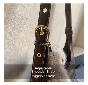 Detail of adjustable leather strap with gold buckle and cute plush doll pendant accessory