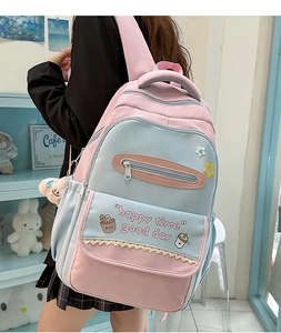 Detailed side view of pink and blue contrast school backpack with cute cartoon prints