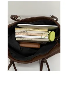 Brown lychee leather tote bag showing spacious interior with laptop, books and umbrella