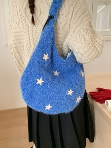 Electric blue plush shoulder bag with white star embroidery and fluffy faux fur texture