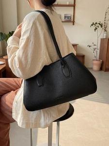 Minimalist black pebble leather tote bag for women with dual shoulder straps and spacious design