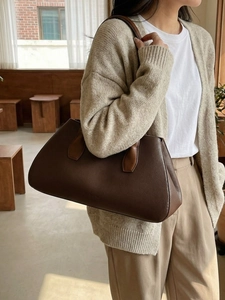 Minimalist dark brown tote bag in pebbled leather shown on model for elegant style