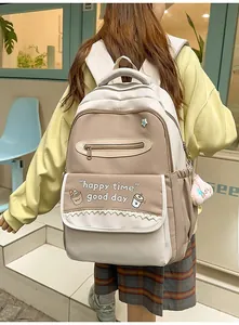 Detail of college style backpack with contrast stitching and cartoon bread print