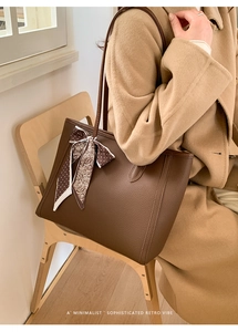 Brown litchi grain tote bag with decorative silk scarf shown from a side shoulder view