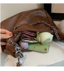 Interior view showing the large capacity of the brown faux leather tote with daily items