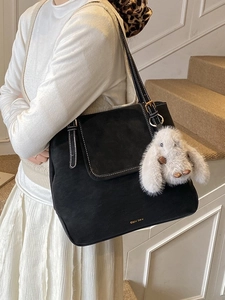 Retro black matte bucket tote bag with white stitching and plush bunny charm