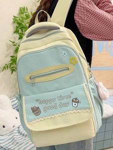 Pastel colorblock school backpack with cartoon prints and plush ball keychain accessory