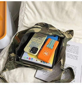 Detailed interior of camo canvas hobo bag showing large capacity for tablet and phones